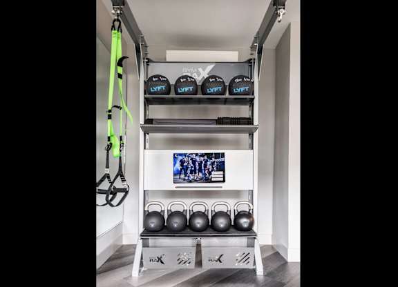 A gym setup with kettlebells and weight lifting equipment.