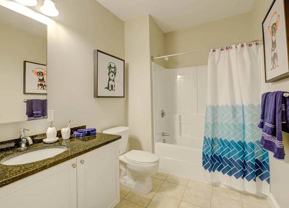 A bathroom with a toilet, sink, and shower.