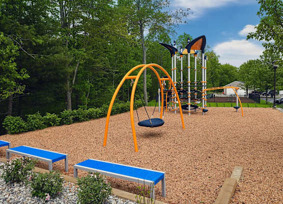 A playground with a swing set and a slide.