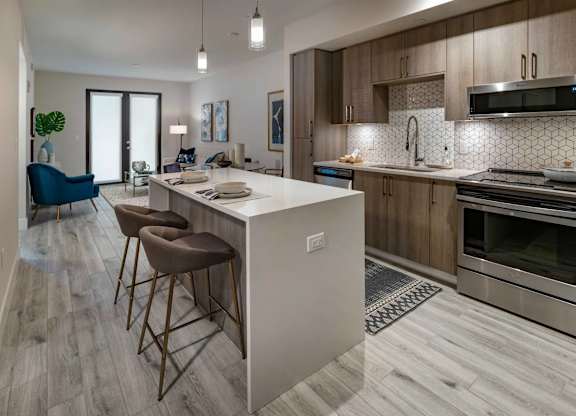A modern kitchen with a bar area and a dining area.