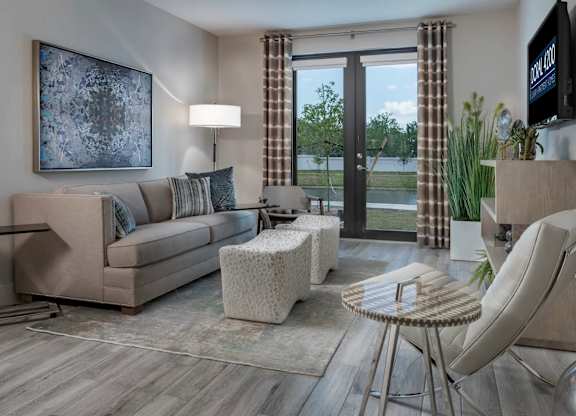 A living room with a couch, chair, and television.