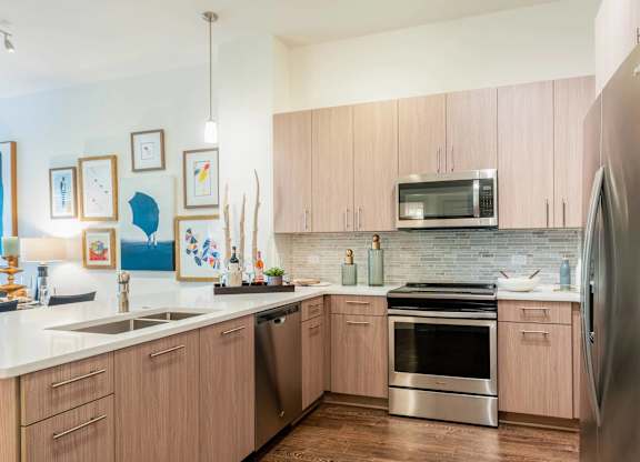 A kitchen with wooden cabinets and stainless steel appliances.