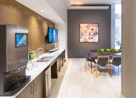 A modern kitchen with a dining table and chairs.