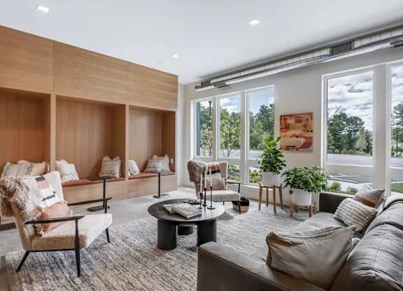 A modern living room with a large window overlooking a street.