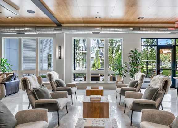 A room with grey chairs and a wooden table.