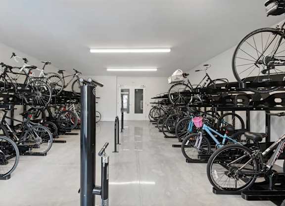 A bike shop with many bikes on stands.