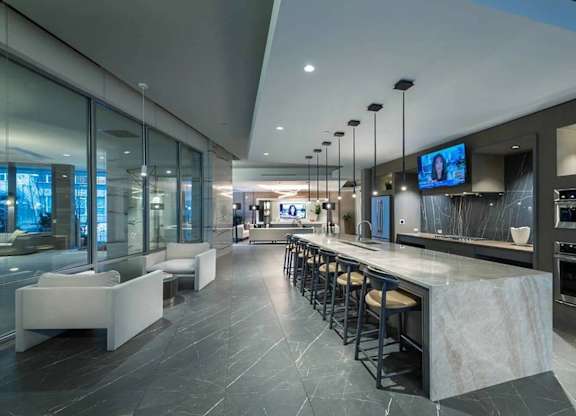 A modern kitchen with a bar area and seating.