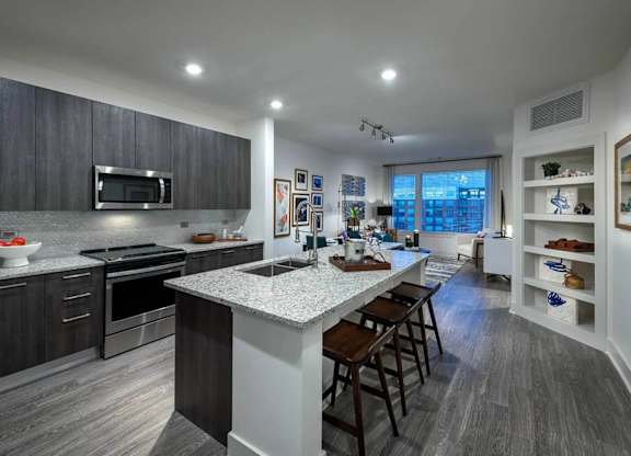 A modern kitchen with dark wood cabinets and a white island.