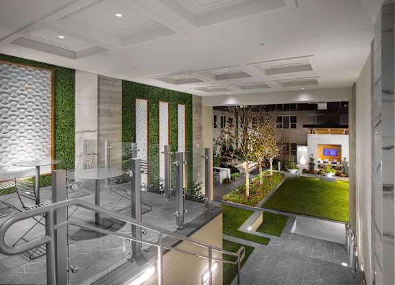 A modern interior space with a glass wall and a green wall.