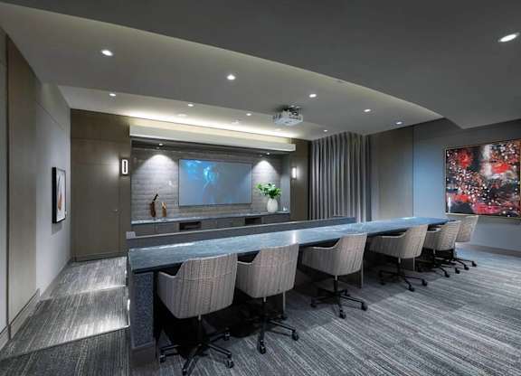 A conference room with a long table and chairs.