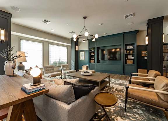 A modern living room with a wooden coffee table and grey sofa.