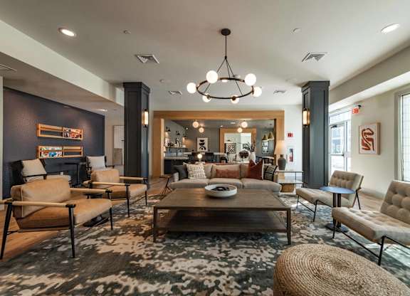 A modern living room with a large rug and a coffee table.