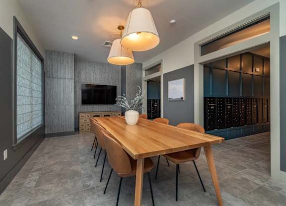 A modern dining room with a wooden table and chairs.