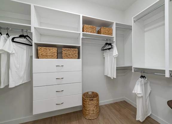 A white closet with drawers and baskets.