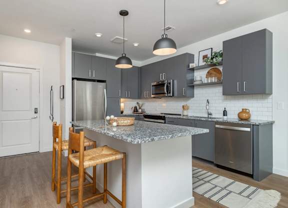 A kitchen with a white door and a wooden chair.