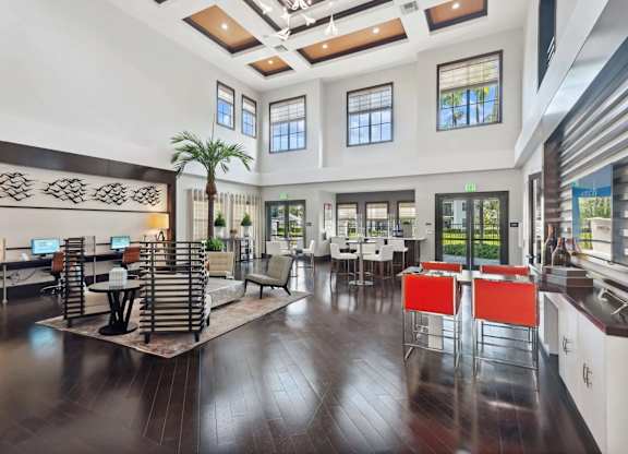A spacious room with a wooden floor and a large window.