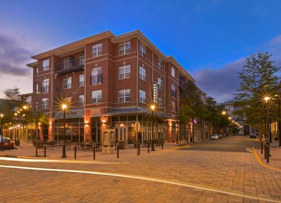 A large red brick building with a balcony on the second floor.