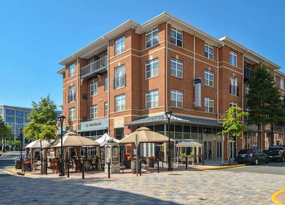 A large brick building with a cafe in front.