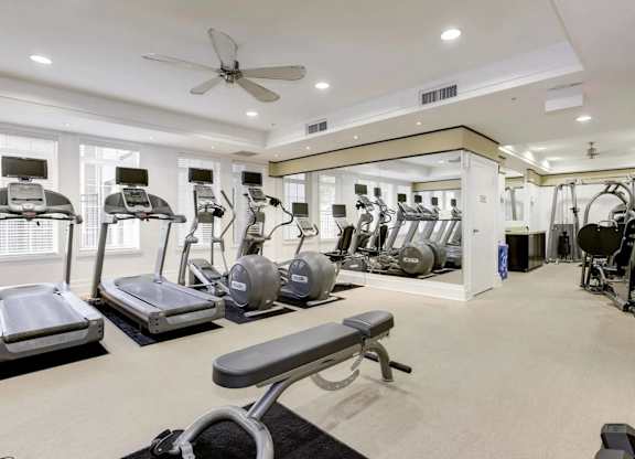 A spacious home gym with a variety of exercise equipment.
