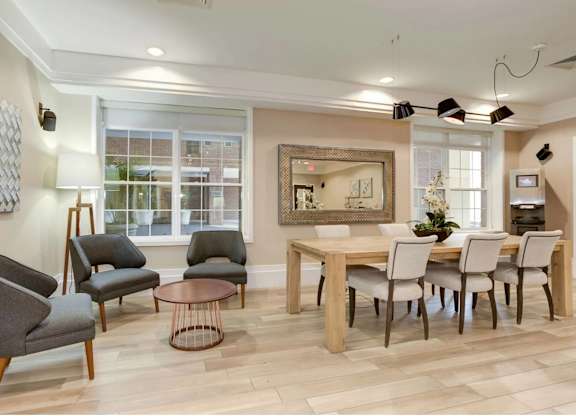 A living room with a dining table and chairs.