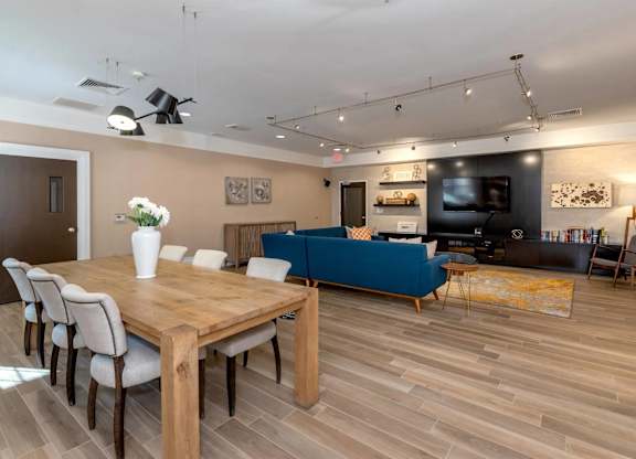 A modern living room with a wooden table and chairs.