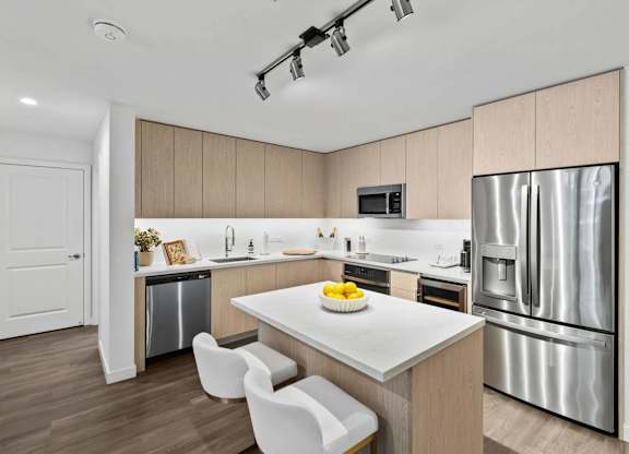 A modern kitchen with a white table and chairs.