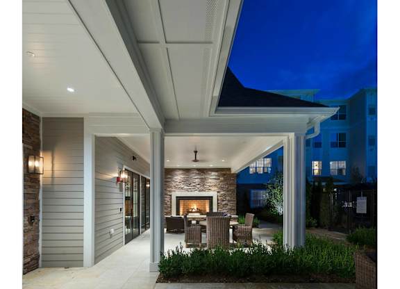 A modern house with a patio and a fireplace.