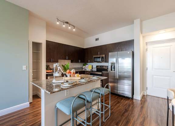 A kitchen with a counter and a refrigerator.
