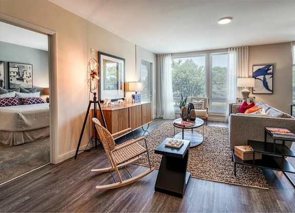 A living room with a rocking chair and a couch.
