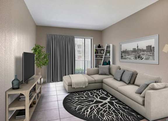 A living room with a grey couch, a television, a plant, and a framed picture on the wall.