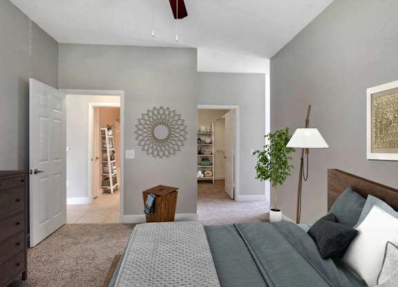A bedroom with a bed, dresser, and mirror.