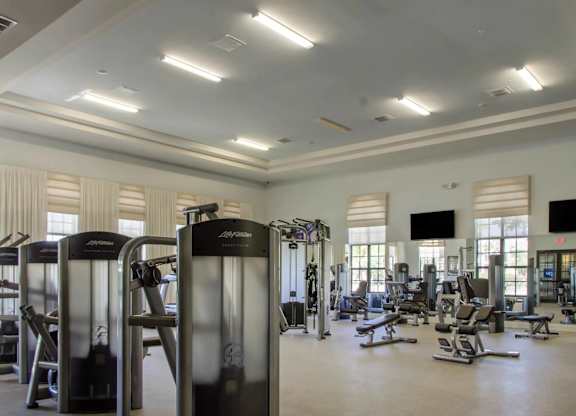 A gym with treadmills, weights and exercise machines.