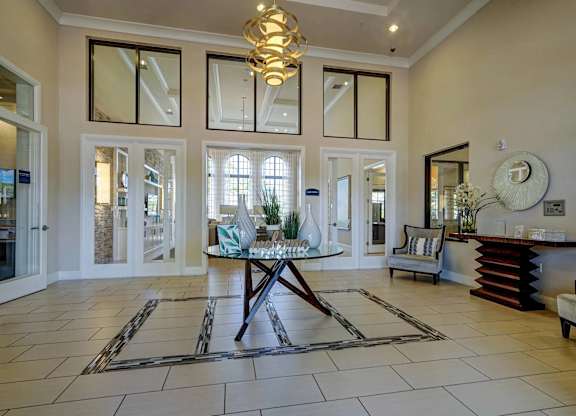 A spacious foyer with a large table and chairs.