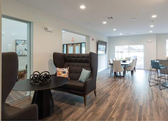 A living room with a brown couch and a black coffee table.
