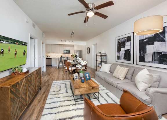 A living room with a grey couch and a wooden coffee table.