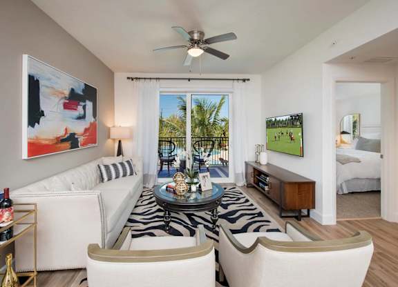 A living room with a zebra rug and a painting on the wall.
