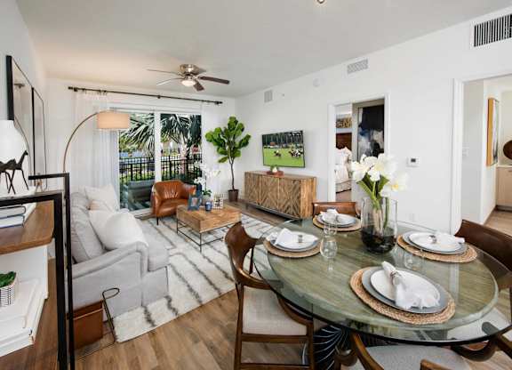 A dining room with a glass table and chairs.
