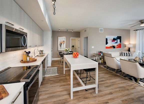 A modern kitchen with a dining table and chairs.