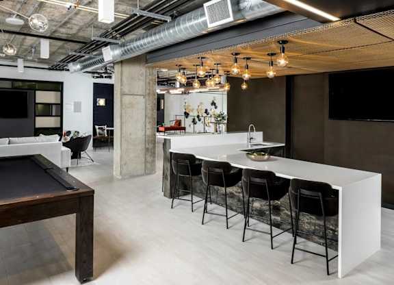 A modern kitchen with a pool table.