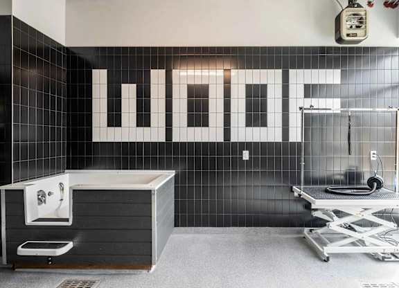 A bathroom with a WOFF sign on the wall.