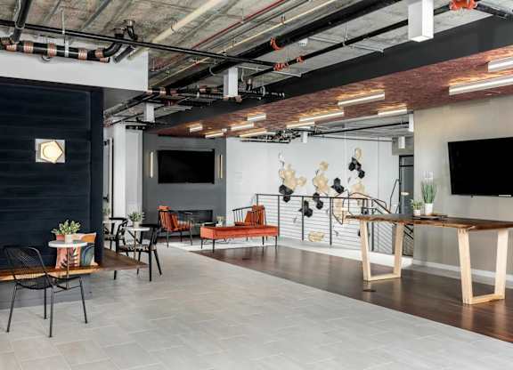 A modern room with a long table and chairs.