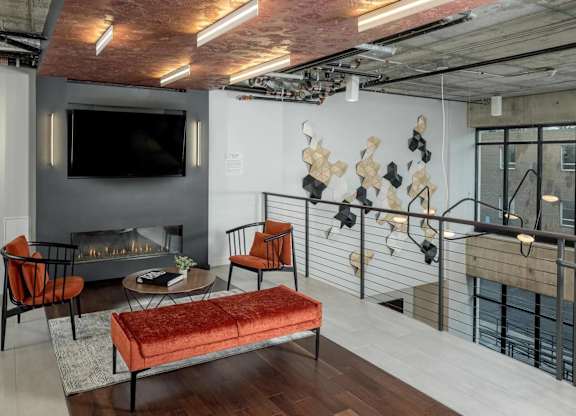 A living room with a fireplace and a television.