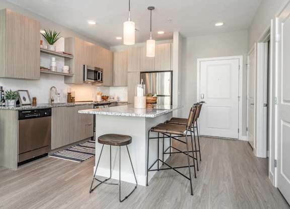 A modern kitchen with a bar stool and a countertop.