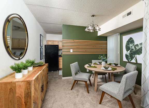 A dining room with a wooden table and chairs.