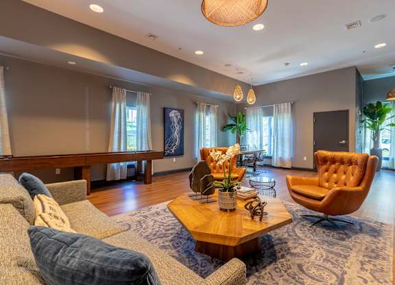 A living room with a brown leather chair and a wooden coffee table.