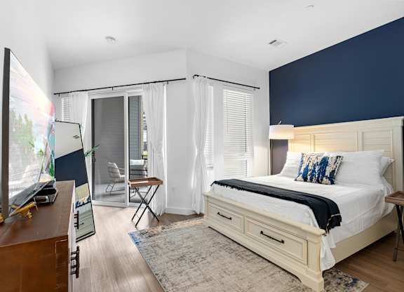 A bedroom with a large bed and a television.