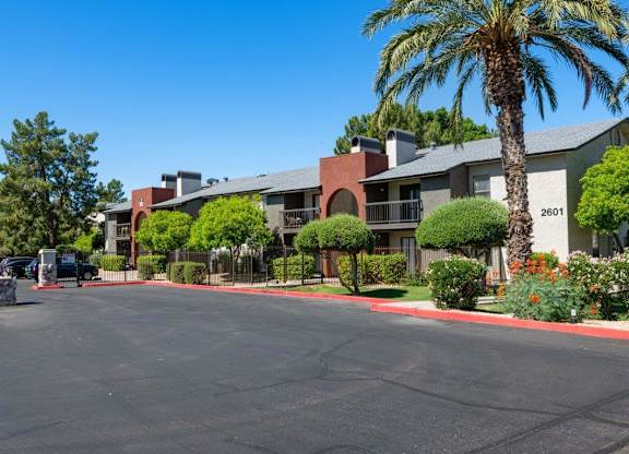 A street view of a residential area with houses and parked cars at Reflections at Red Mountain Apartments, Mesa 85213