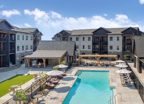 A large building with a pool in front.