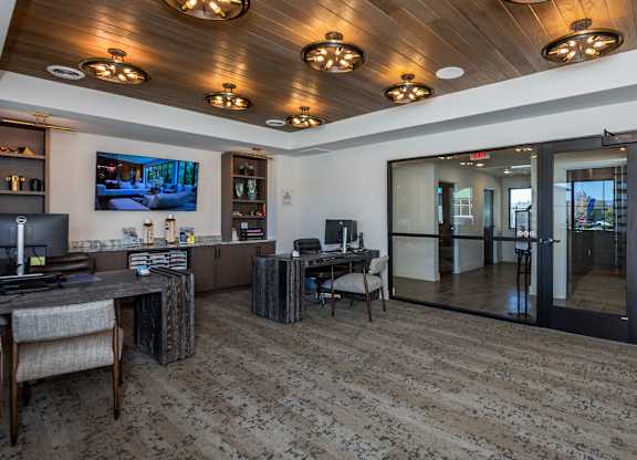 A room with a wooden ceiling and a television mounted on the wall.