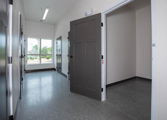 A room with a grey floor and a grey door.